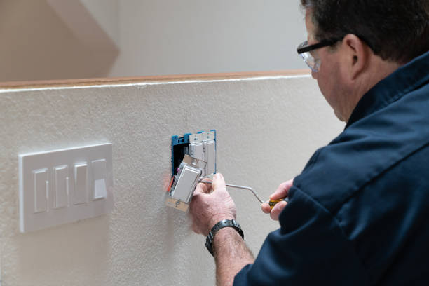 Electrician installing a light switch