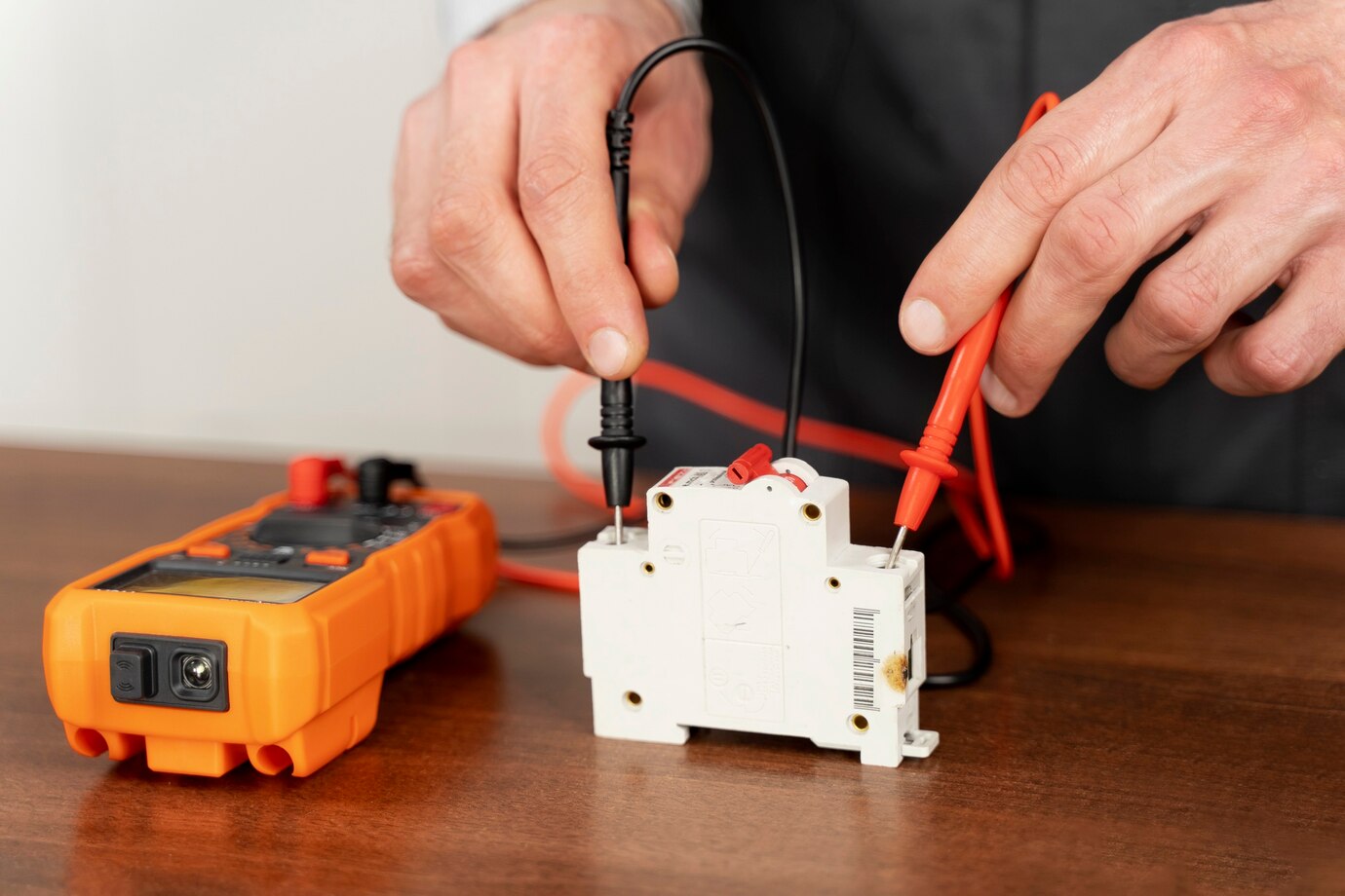 Technician testing electrical components with multimeter